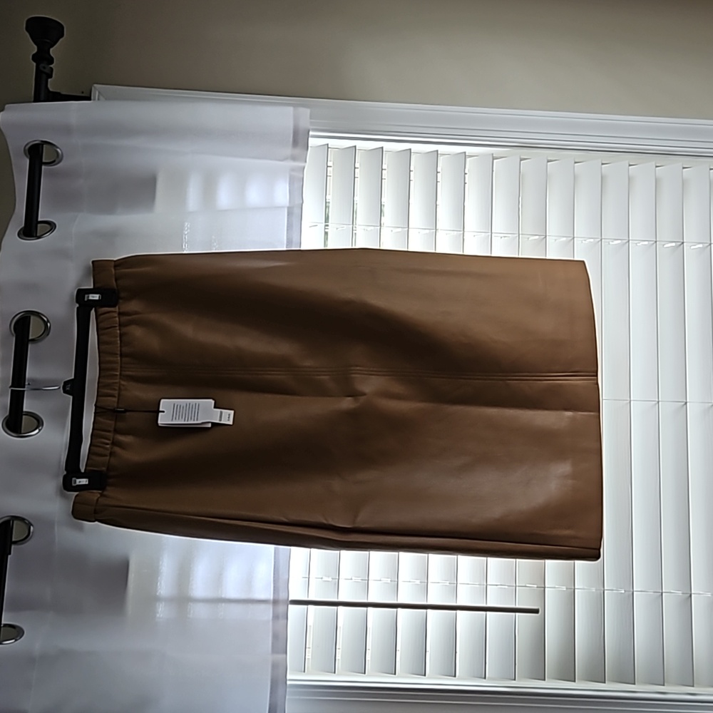 Faux  leather long skirt to  below knees  slit in back beige  never worn